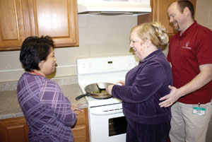 Morningstar staff helping residents in the kitchen.